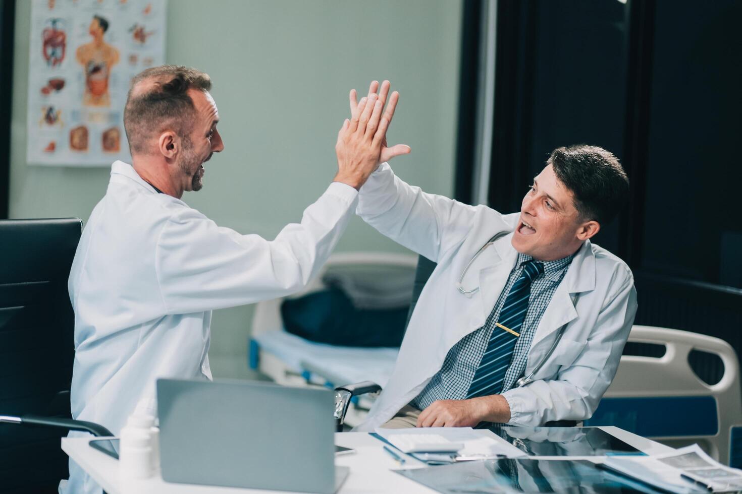Smiling young male clinician shake hands with happy teammate appreciate for assistance on surgery show support respect on team council. Two doctors partners handshaking making deal reaching agreement photo