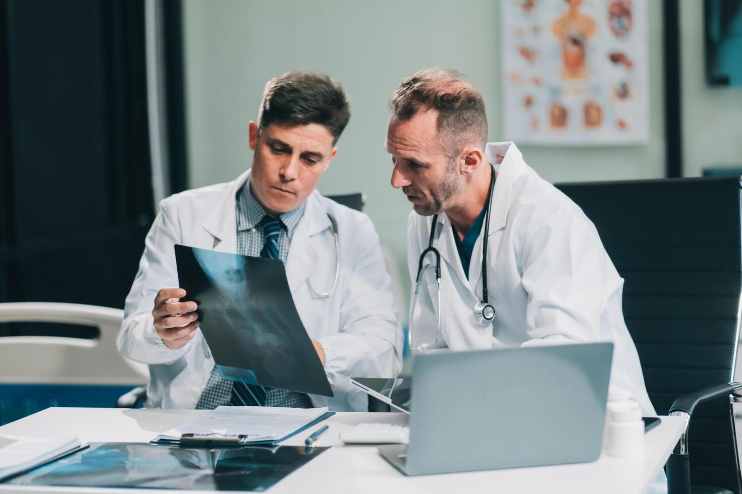 Group of medical practitioners working together and analyzing medical scan in the hospital photo