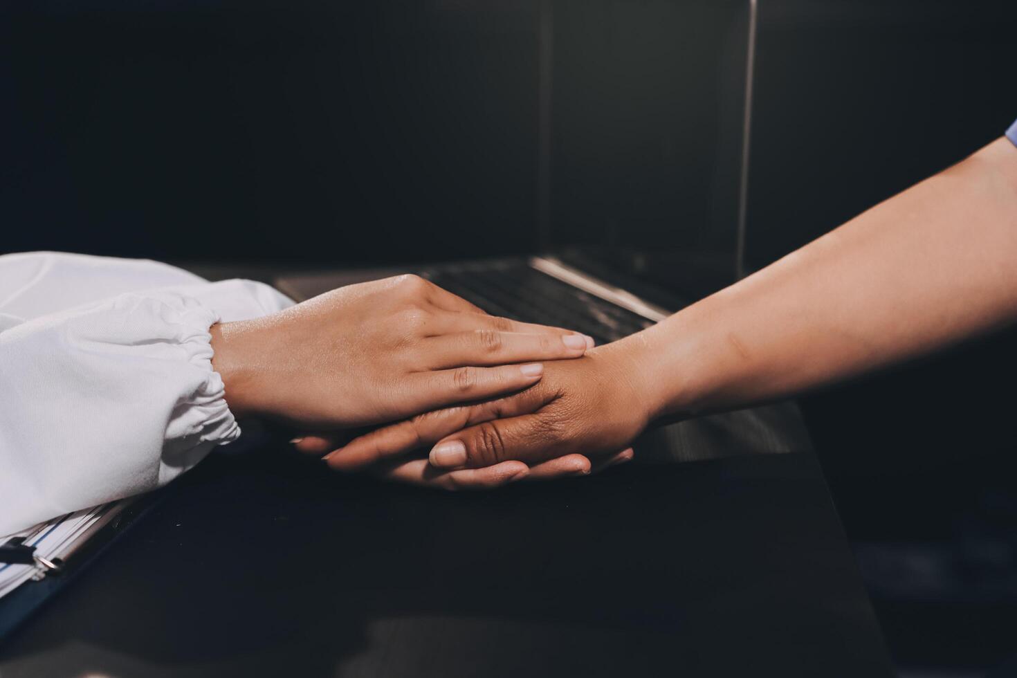 Kind male doctor wearing white coat consulting elder senior female patient holding hand of older woman giving help, safety, empathy and support, showing care and compassion concept. Close up view photo