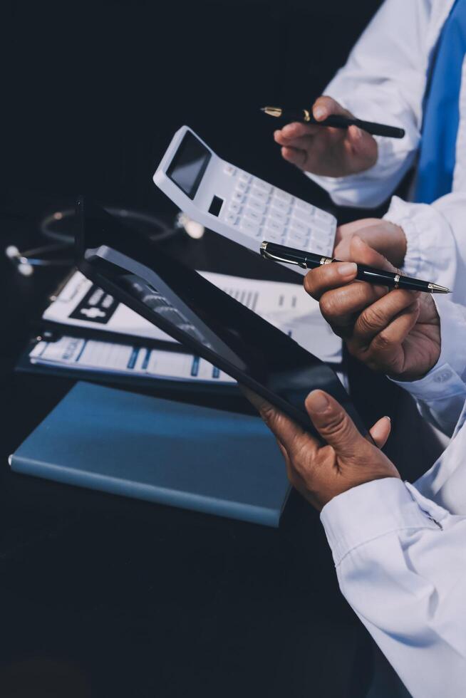 Medical team working on digital tablet healthcare doctor technology tablet using computer analyzed the results of medical reports at the hospital. photo