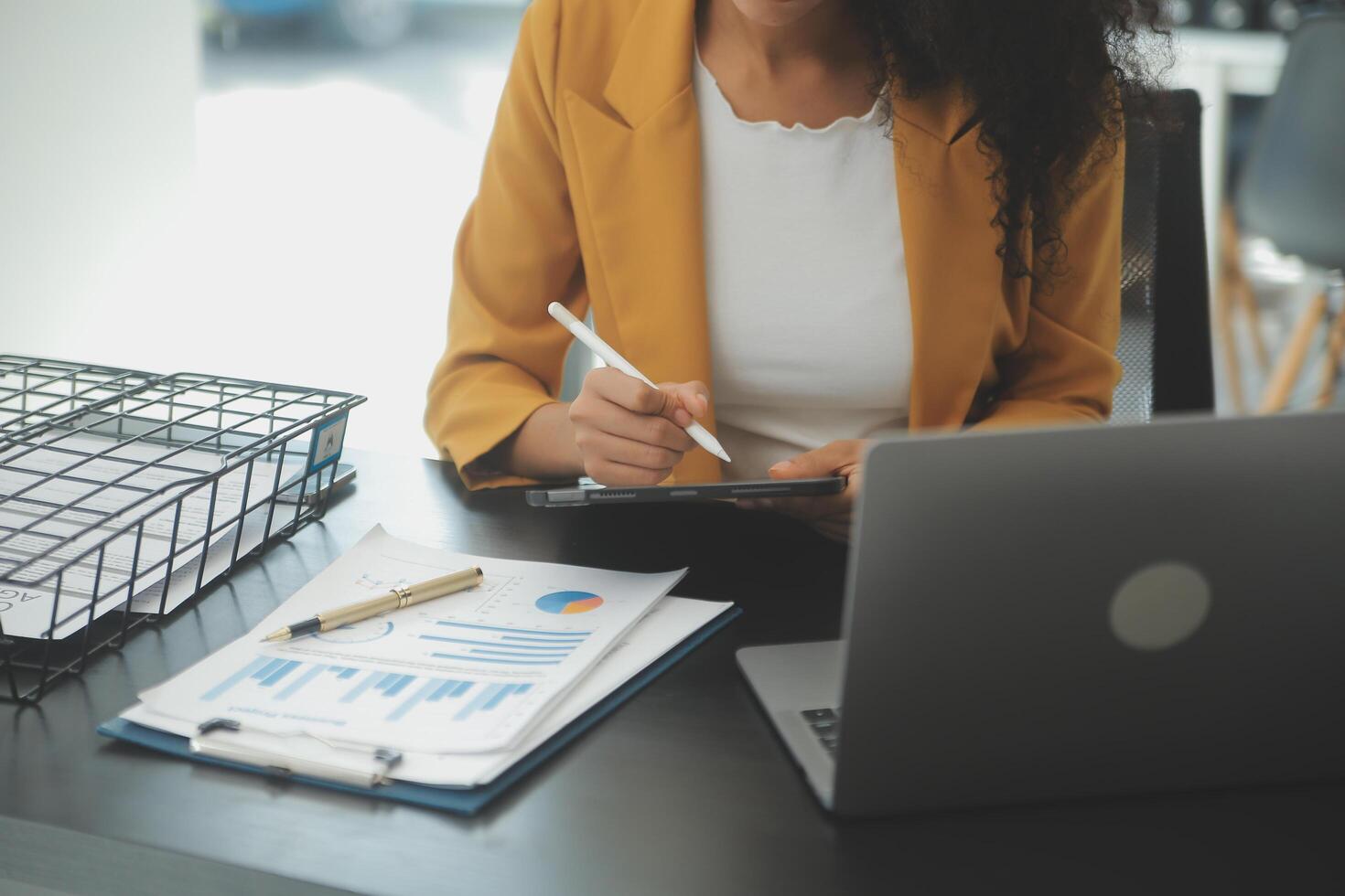 Close up Business woman using calculator and laptop for do math finance on wooden desk, tax, accounting, statistics and analytical research concept photo