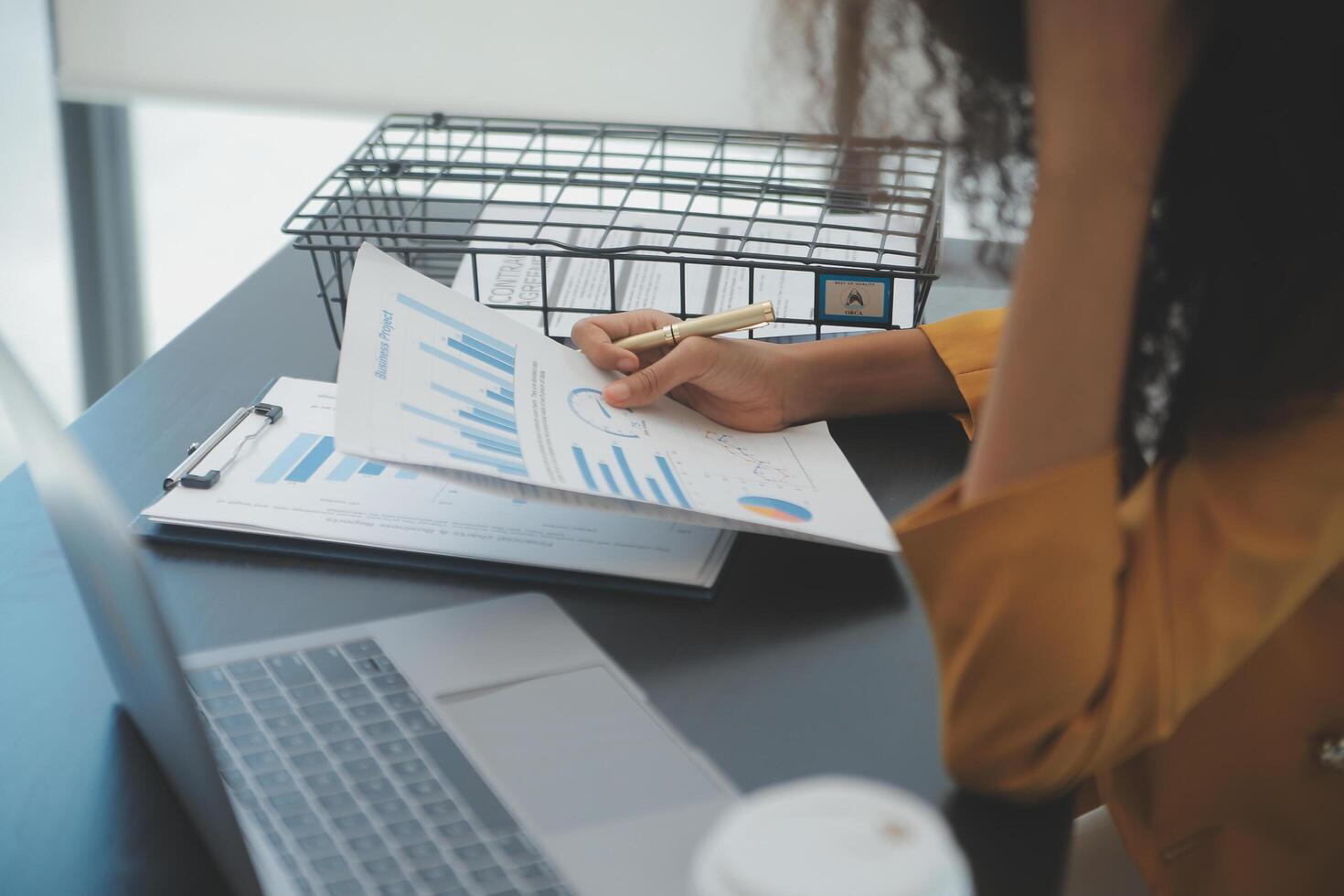 Close up Business woman using calculator and laptop for do math finance on wooden desk, tax, accounting, statistics and analytical research concept photo
