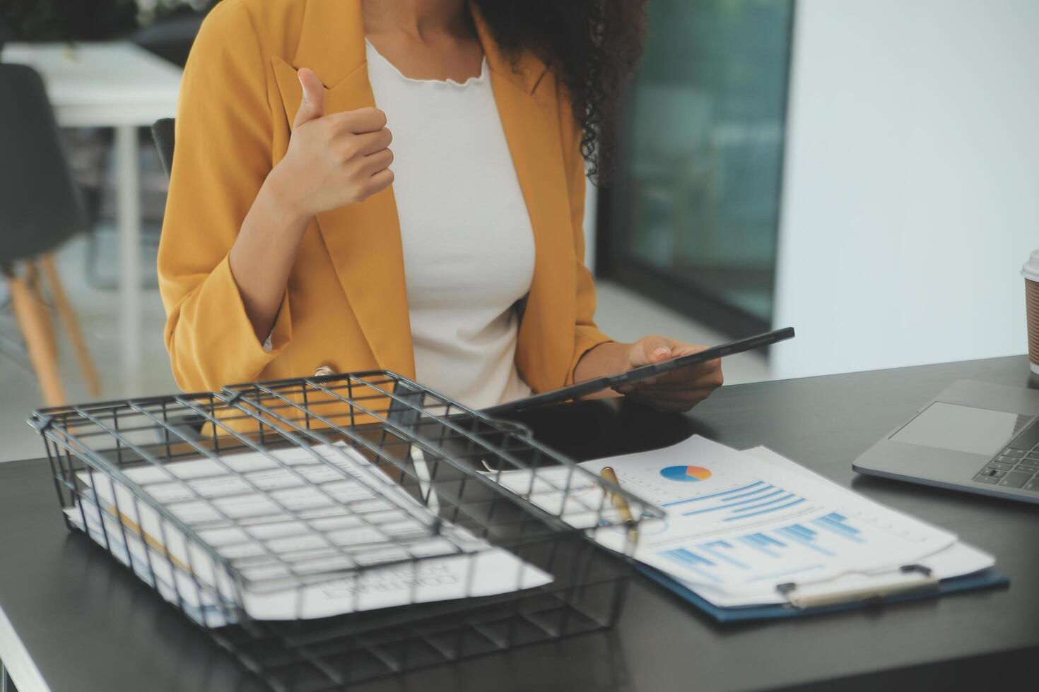 Close up Business woman using calculator and laptop for do math finance on wooden desk, tax, accounting, statistics and analytical research concept photo