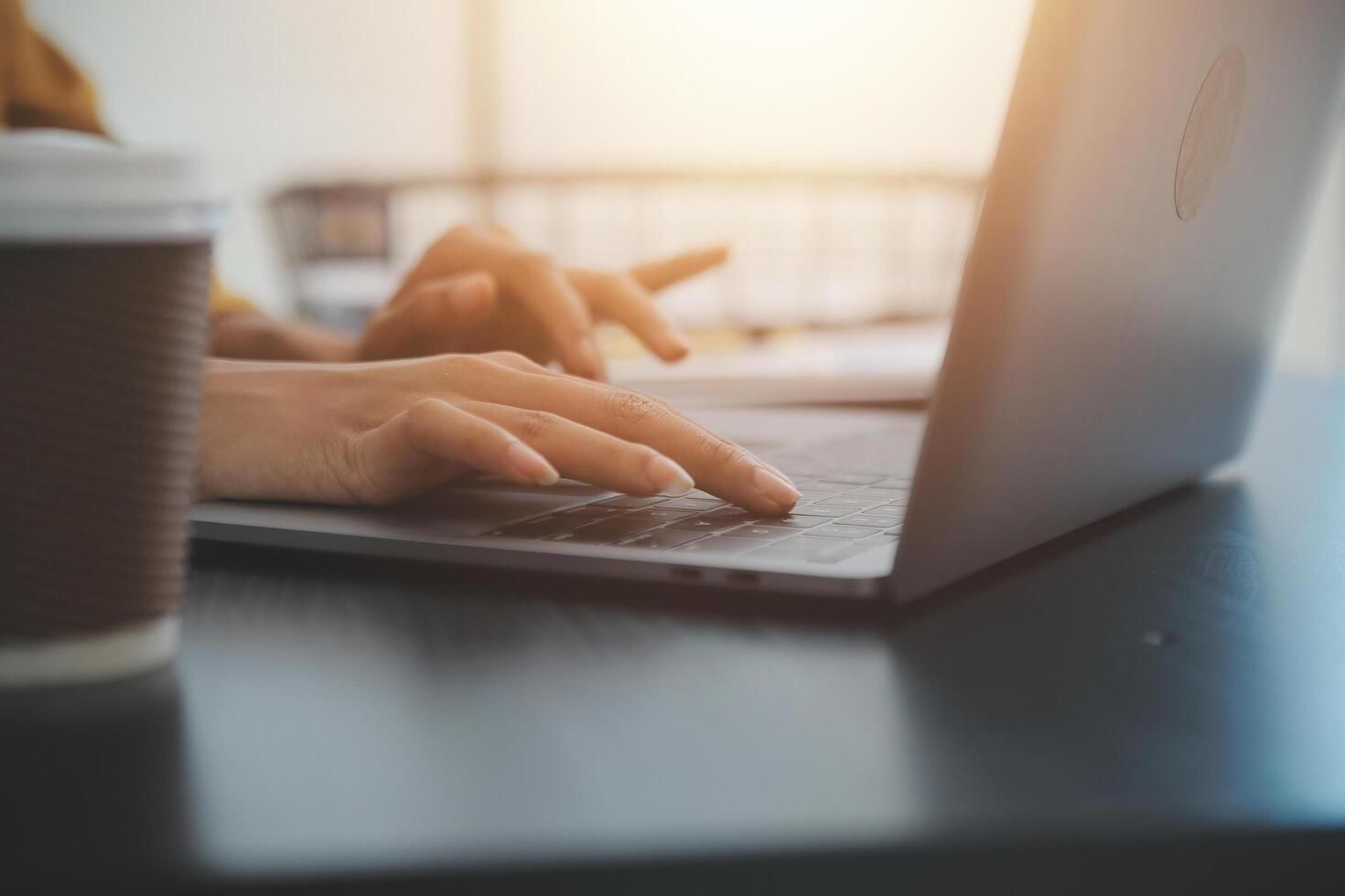 Close up Business woman using calculator and laptop for do math finance on wooden desk, tax, accounting, statistics and analytical research concept photo