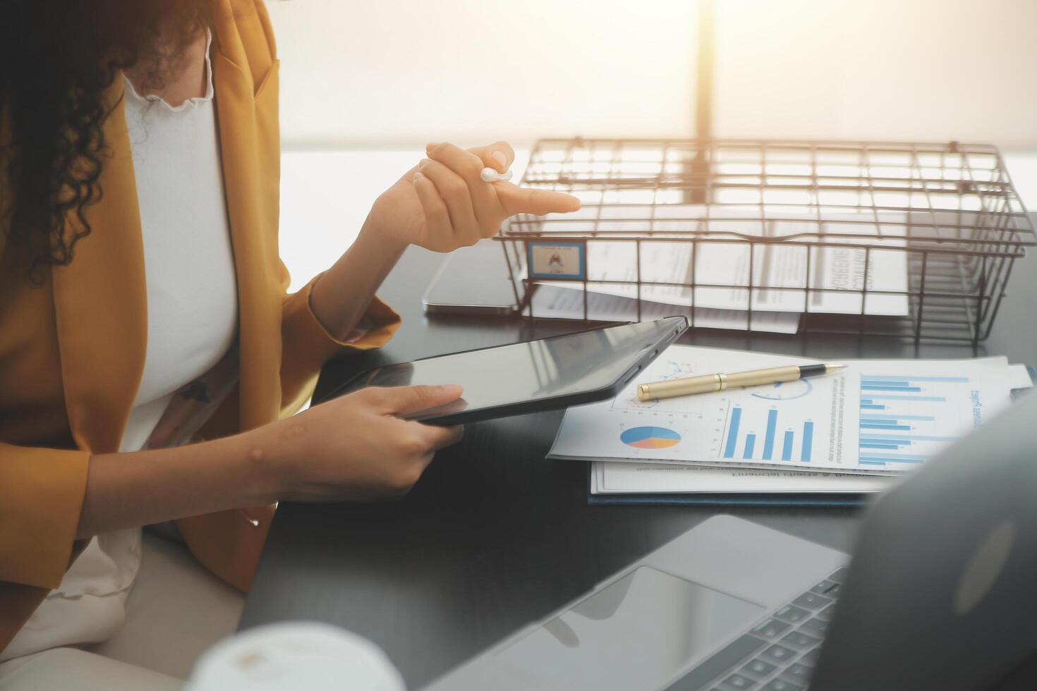 Close up Business woman using calculator and laptop for do math finance on wooden desk, tax, accounting, statistics and analytical research concept photo