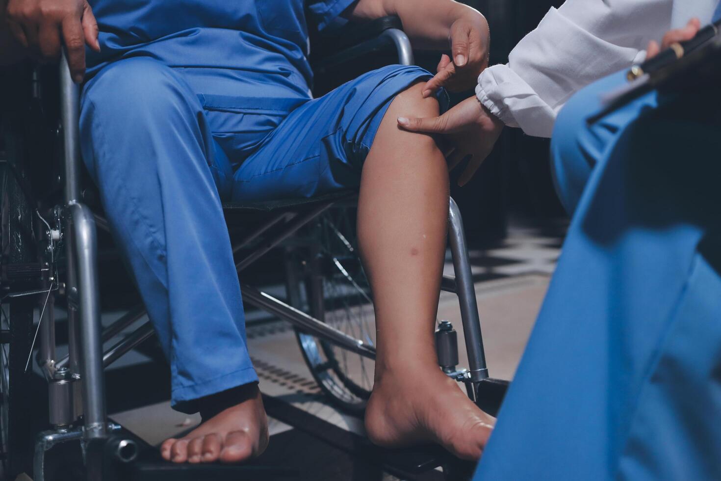 Physiotherapist nurse doing physiotherapy to rehabilitate leg of elderly female patient. photo