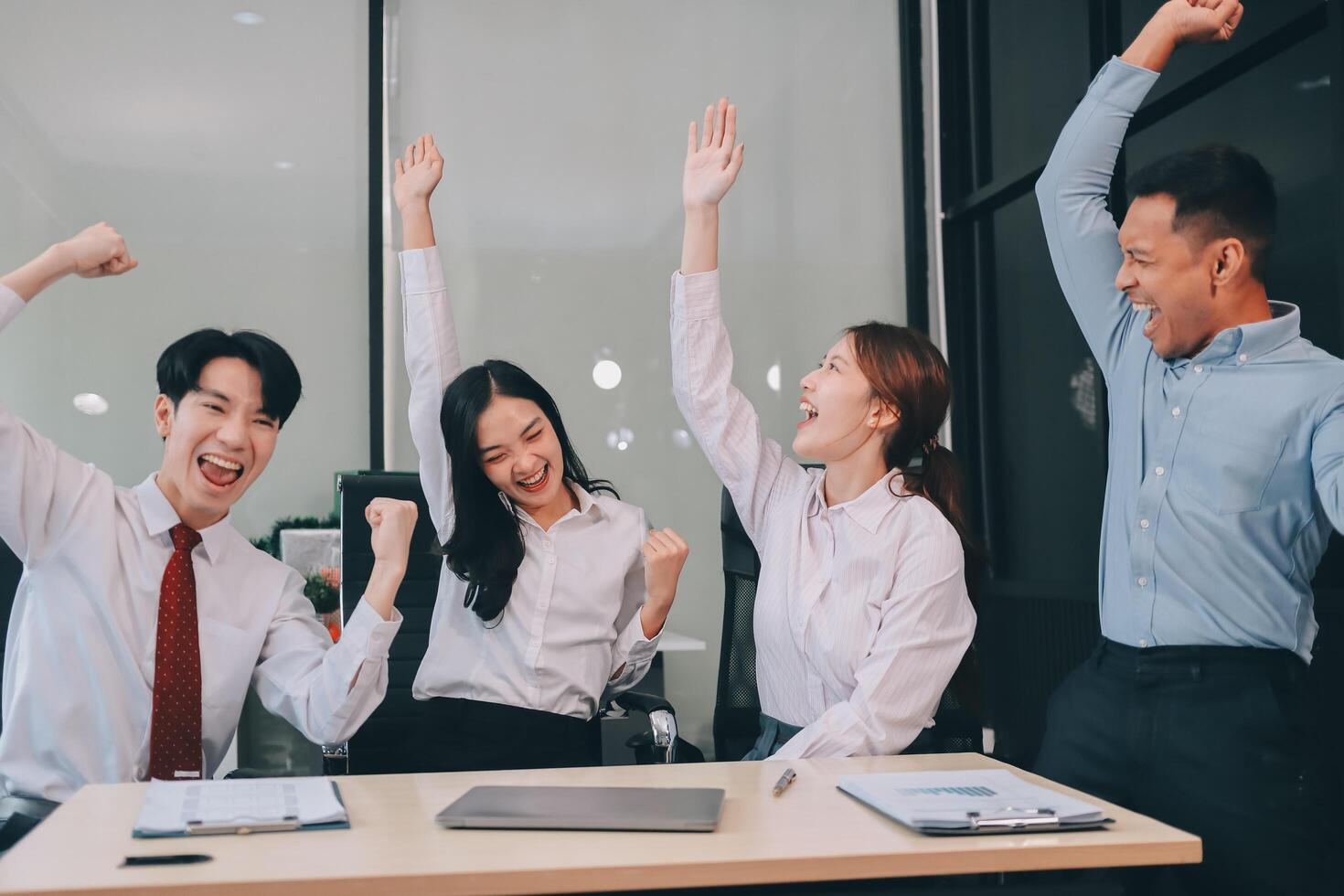 Group of business workers standing with hands together at the office photo