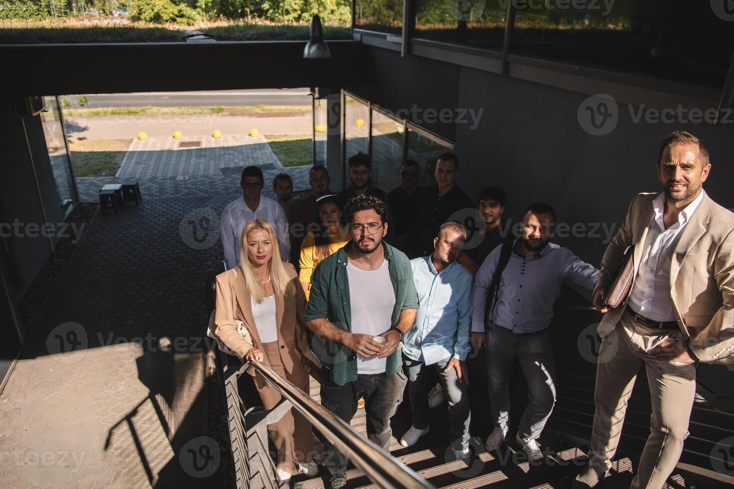 A diverse group of businessmen and colleagues walking together by their workplace, showcasing collaboration and teamwork in the company. photo