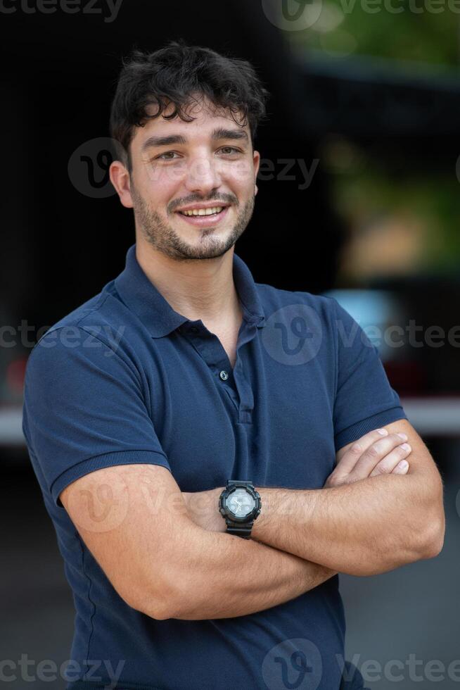 Portrait of a young successful entrepreneur in front of the company photo