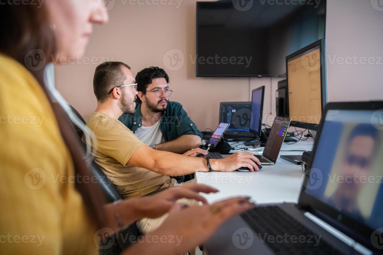 Top view of programmer diligently testing smartphone applications while sitting in their office. photo