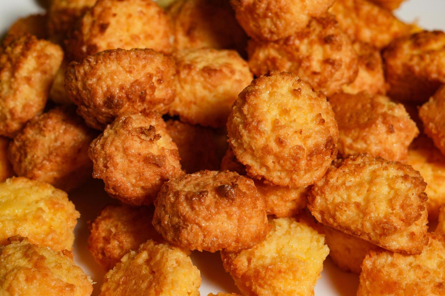 A close up of a pile of fried cheese balls photo