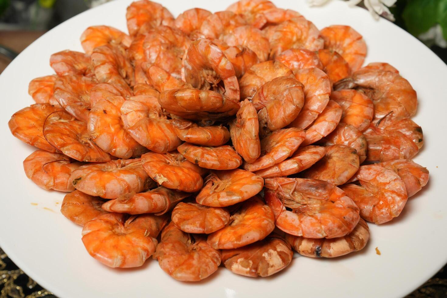 A plate of cooked shrimp on a table photo