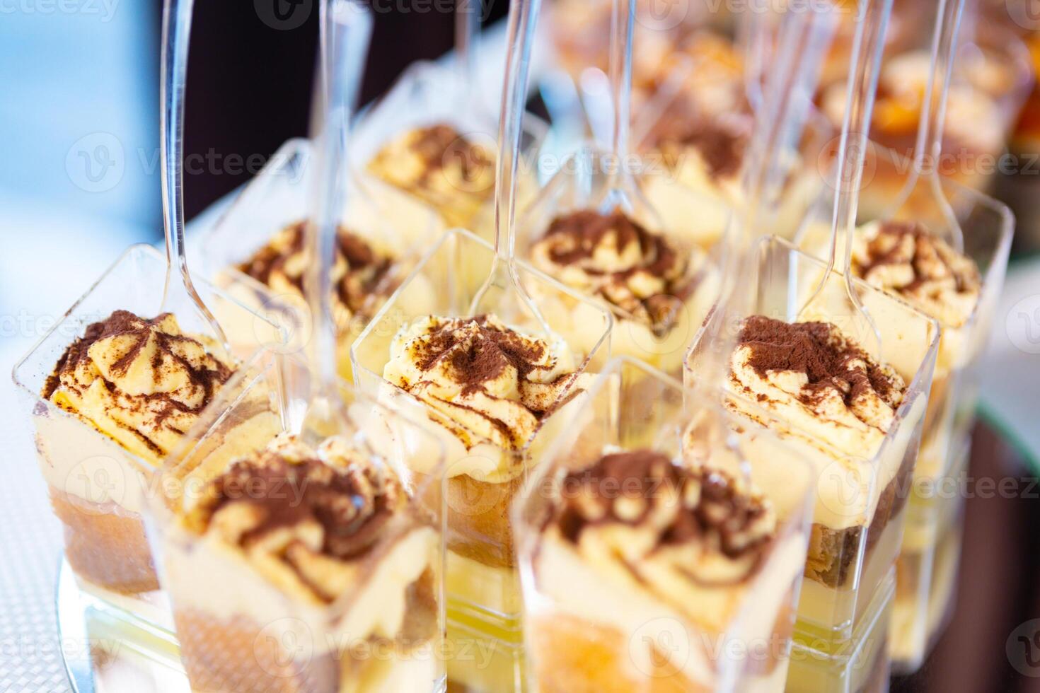 Delicious Layered Desserts in Clear Cups Displayed at a Festive Celebration Event photo