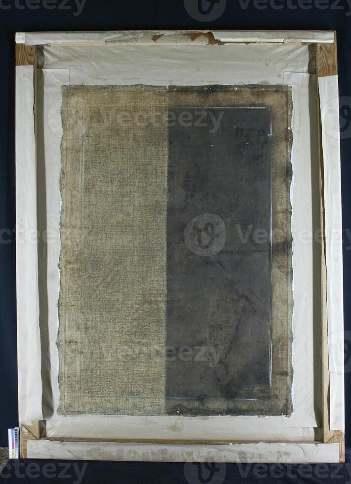 restoration and conservation of a very old canvas, restoration of a painting, restorer at work, place for text photo
