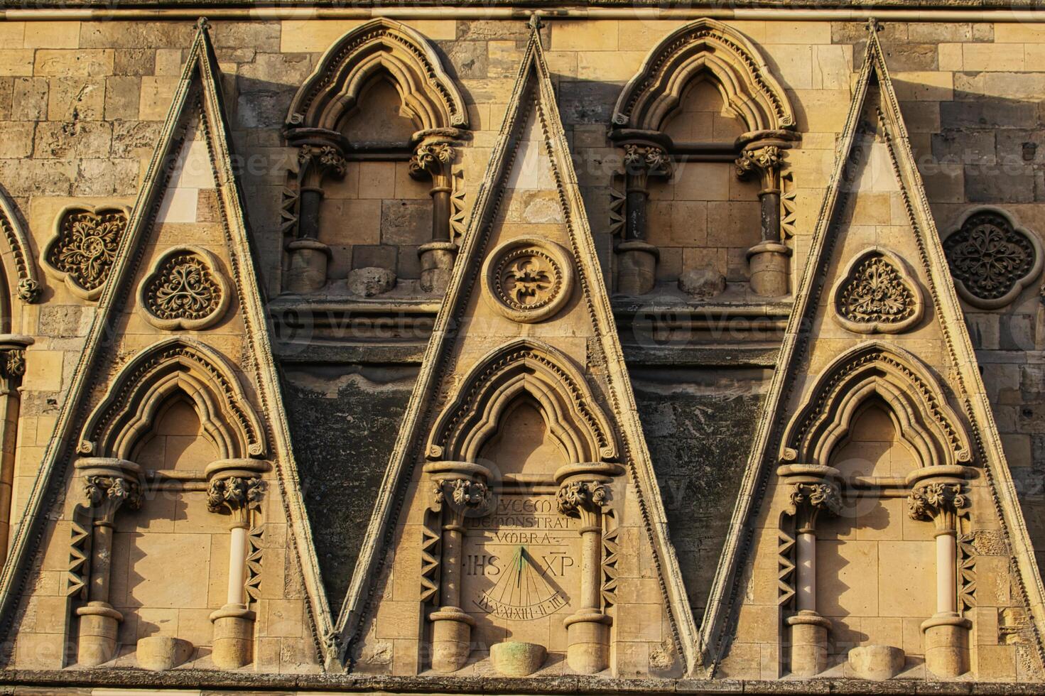 Stone Wall with Triangular Arches and Sundial in York, North Yorkshire, UK. photo