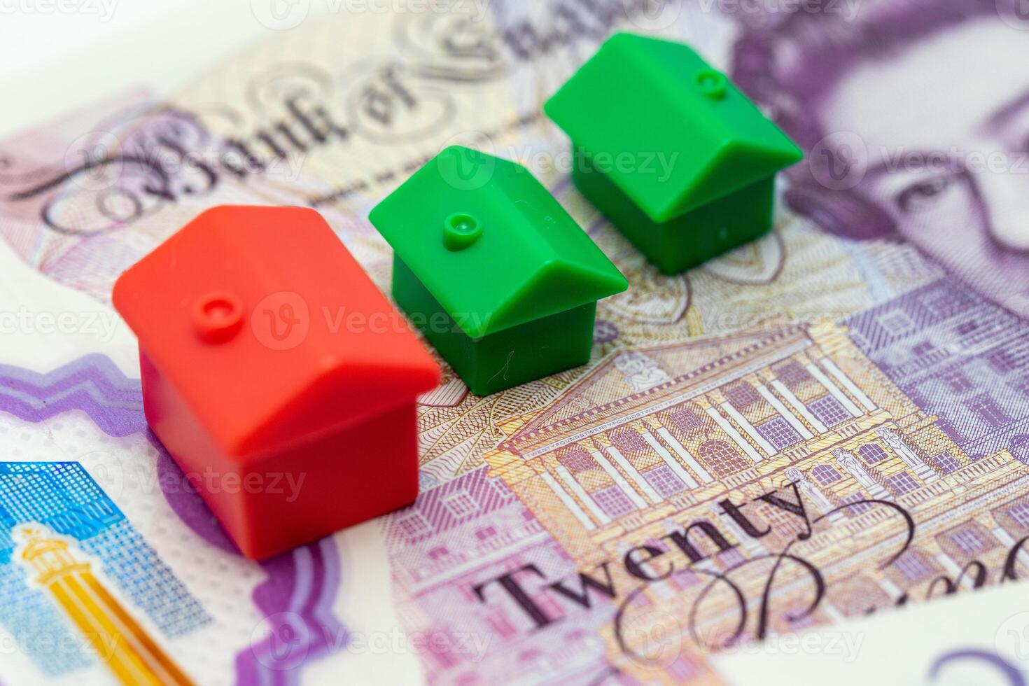 A house model is sitting on top of a twenty pound note photo