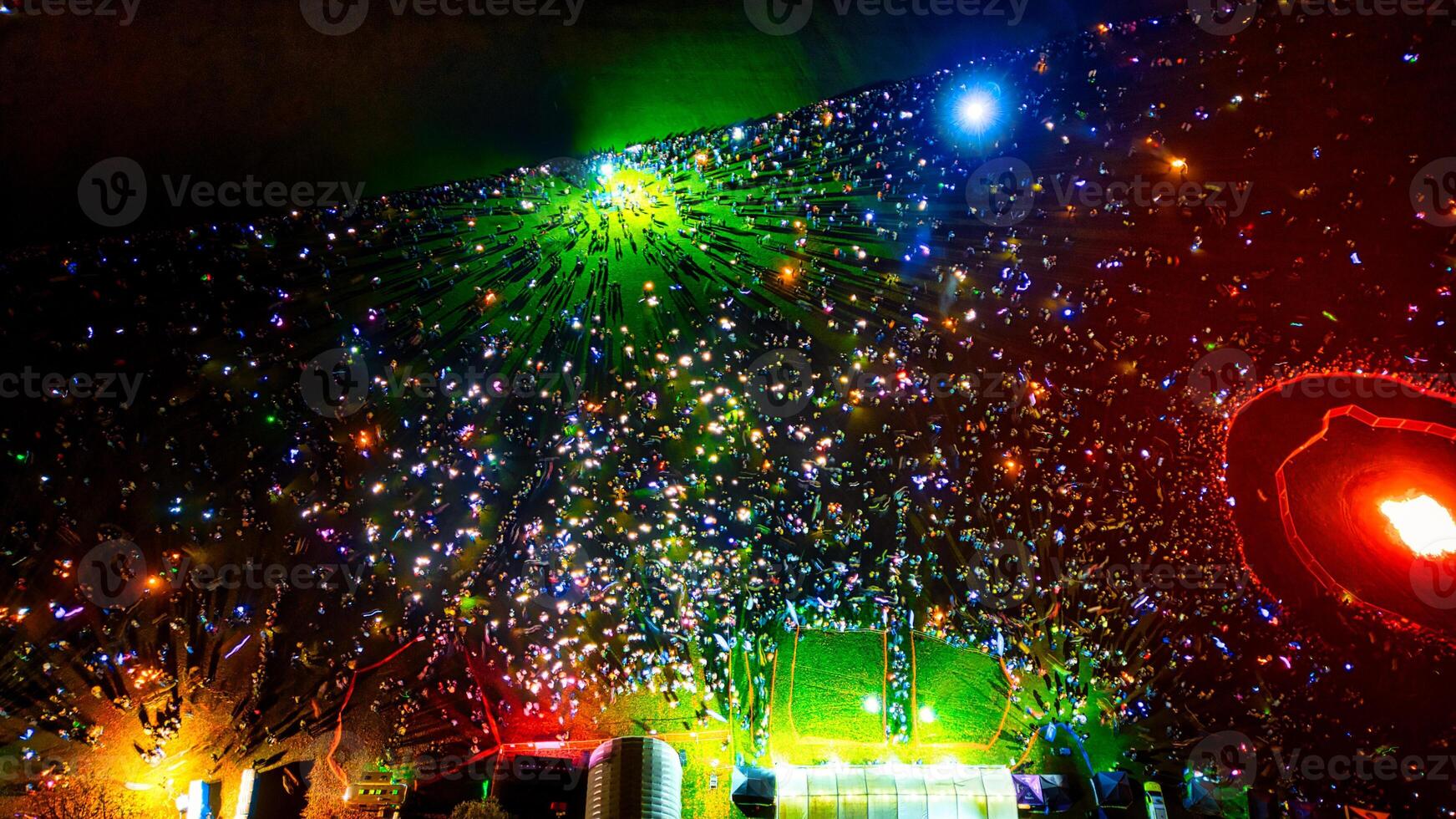 Aerial View of Crowd at Nighttime Festival with Bonfire photo