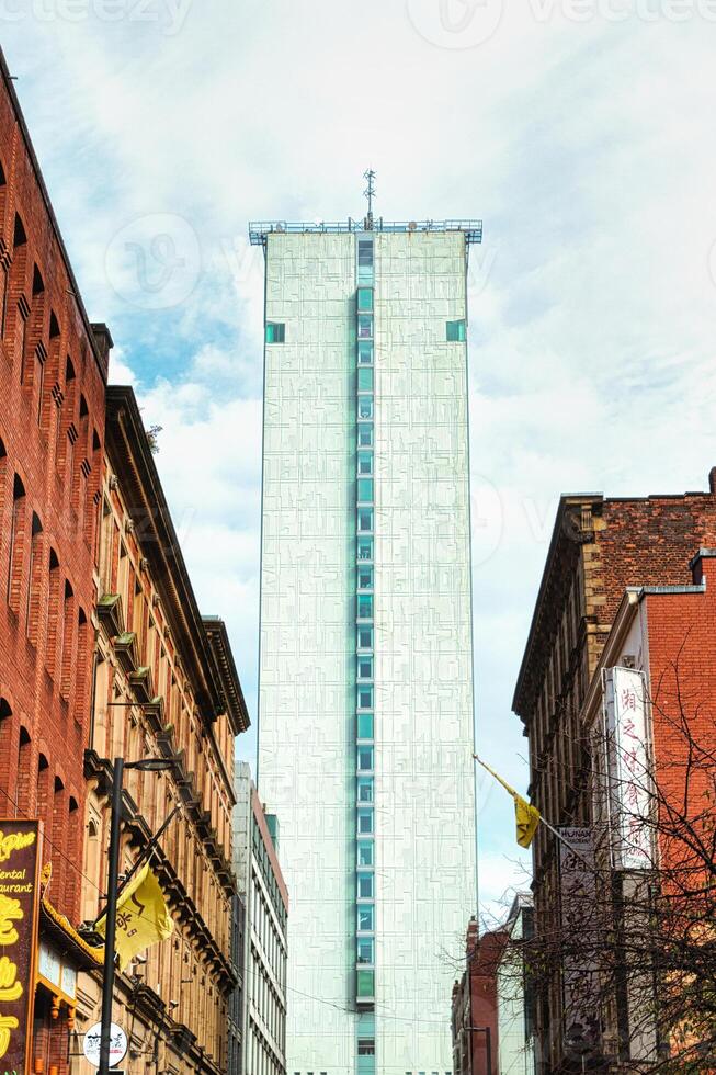 Tall White Building with Grid Pattern and Windows in Urban Setting photo