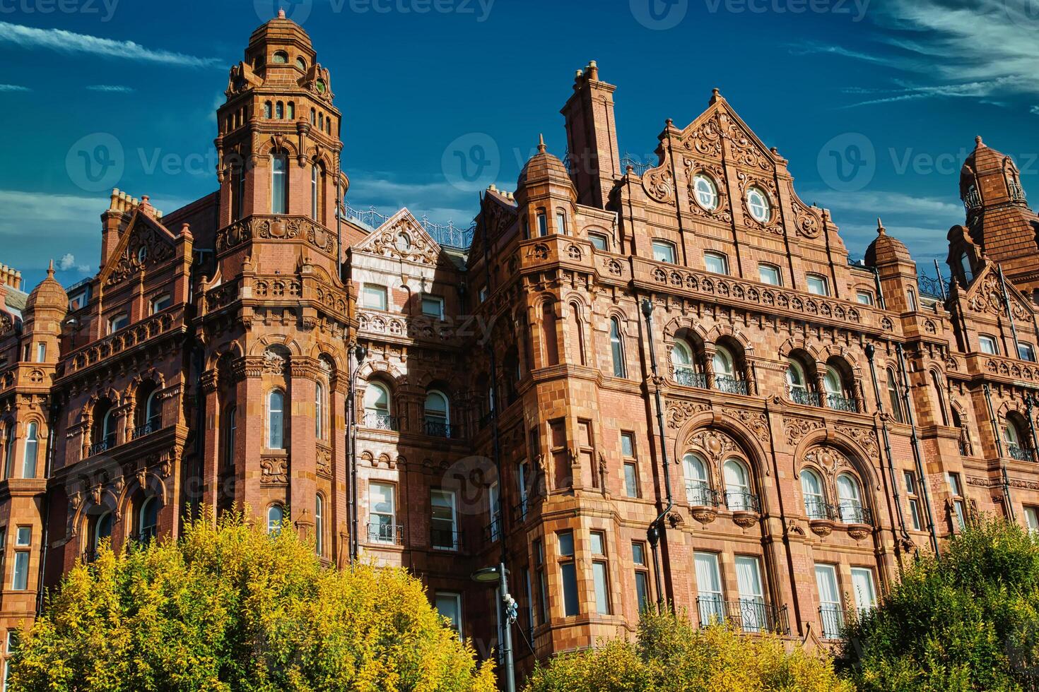 Red Brick Building with Ornate Details and Clock Face photo