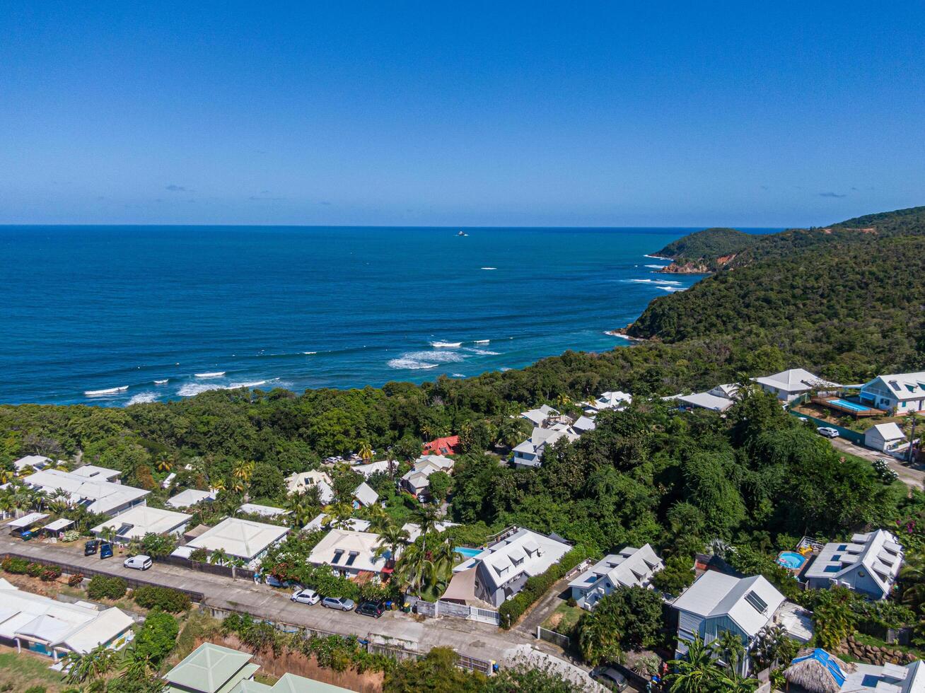 Aerial view of houses on top of surfers' beach, Tartane, Martinique, West Indies, France photo