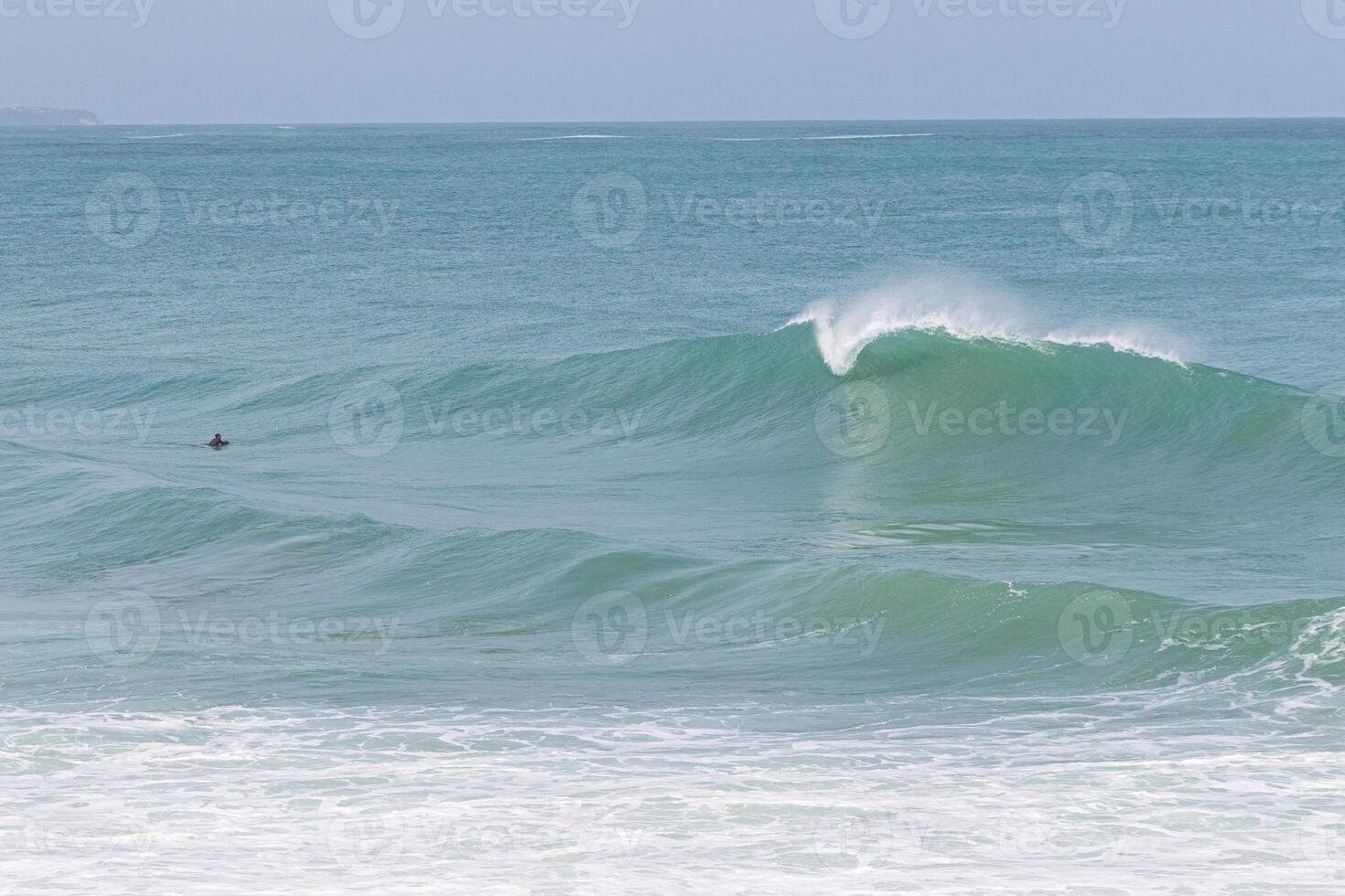 Perfect A frame wave in front of bodyboarder, VVF beach, Tartane, Martinique, West Indies, France photo