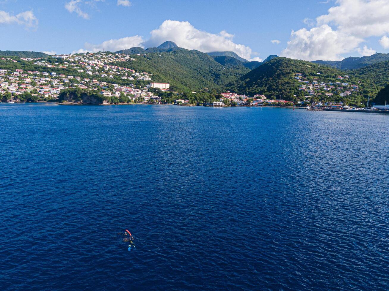 2 scuba divers getting back at the surface in Case-Pilote, Martinique, West Indies, France photo