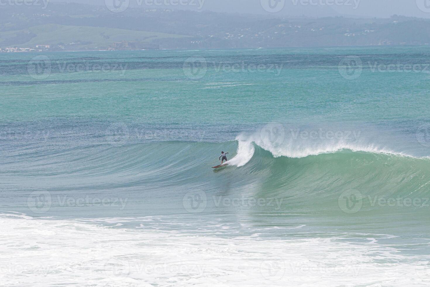 Surfer riding a wave front side at VVF, Anse l'etang, tartane, Martinique, West Indies, France photo