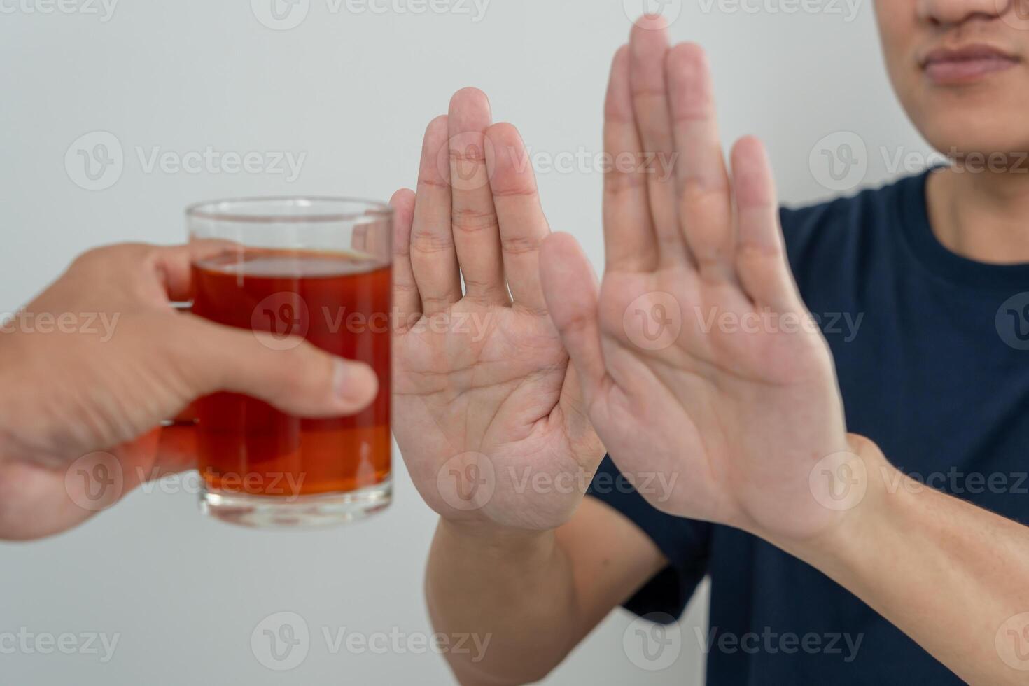 man refuses say no and avoid to drink an alcohol whiskey, stopping hand sign male, alcoholism treatment, alcohol addiction, quit booze, Stop Drinking Alcohol. Refuse Glass liquor, unhealthy, reject photo