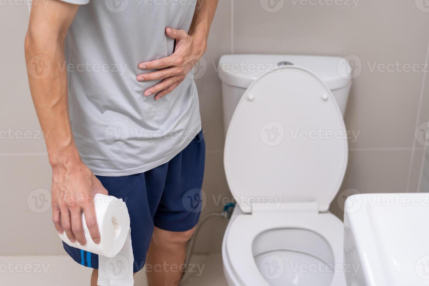 Constipation and diarrhea in bathroom. Hurt man touch belly stomach ache painful. colon inflammation problem, toxic food, abdominal pain, abdomen, constipated in toilet, stomachache, Hygiene photo