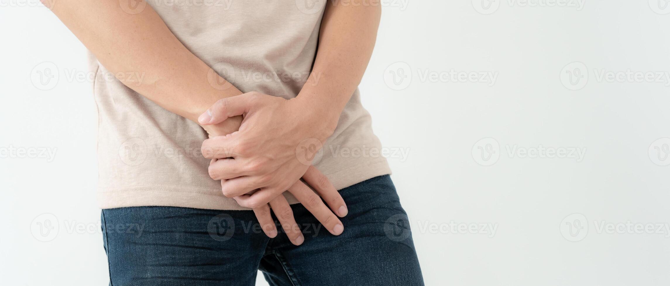 Man hold hand in front of private parts feeling discomfort from disease and inflammation. Venereal, testicular cancer. bladder problems, erectile dysfunction, premature ejaculation, prostate cancer photo