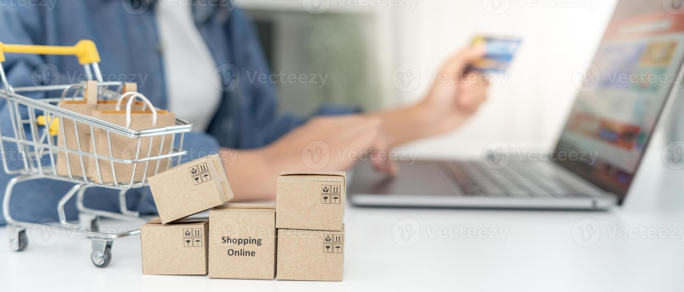 woman using laptop for online shopping at home. Hand holding mobile phone with payment detail page display and credit card, stay home, technology, electronic commerce, internet, market place photo