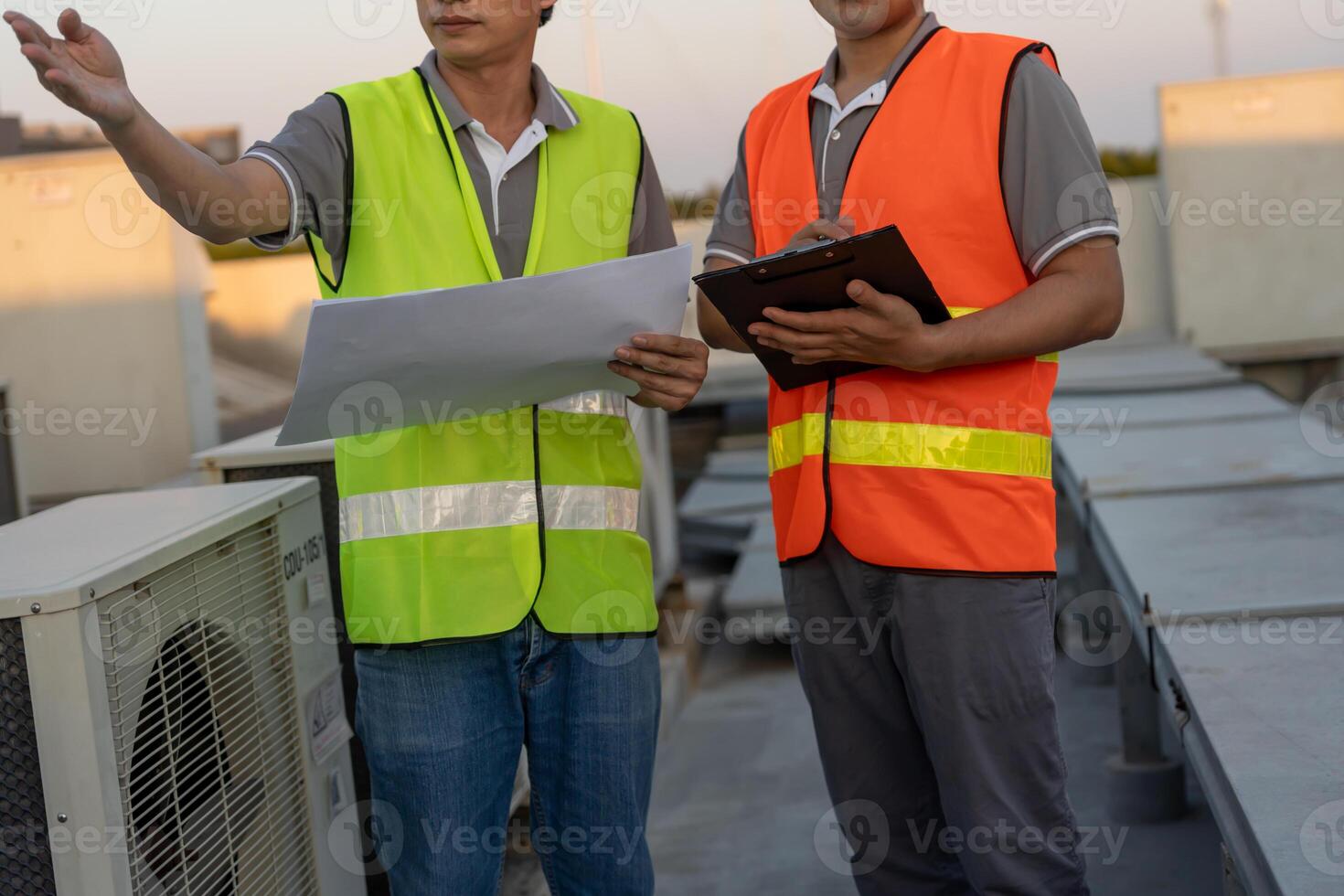 Engineers use blueprint check air condition systems on site. Contractor and inspector inspection compressor during project. maintenance team check quality assurance. Audit, inspect, quality control. photo