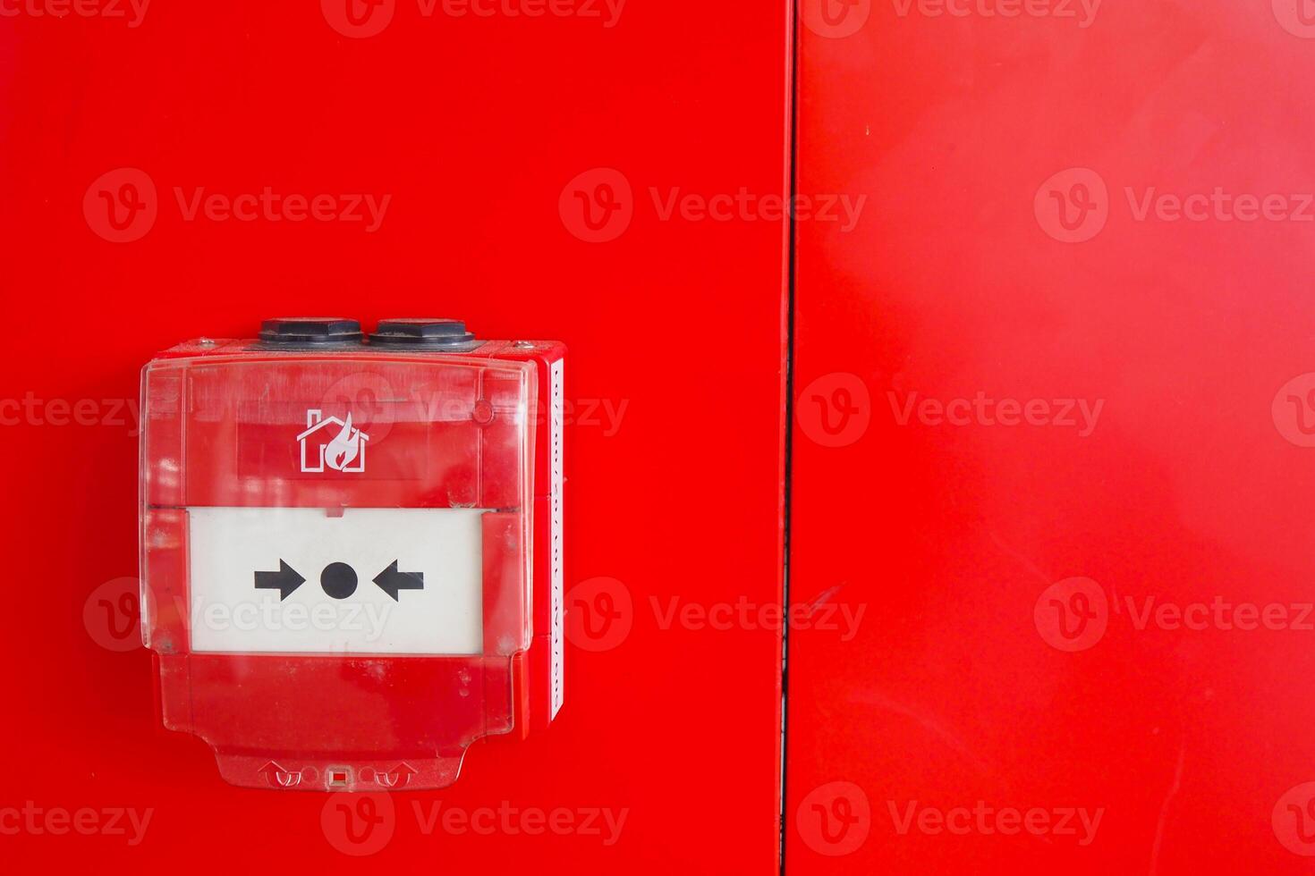 Red fire alarm button on wall , photo