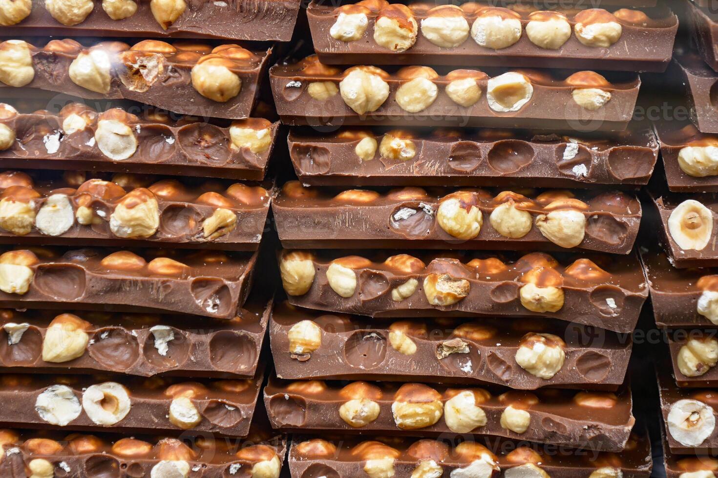 Indulge in these Delicious Chocolate Bars with Hazelnuts Stacked Neatly for a delightful experience photo