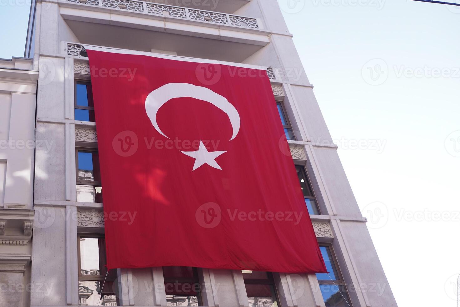 A low angle shot of Turkish national flag hanging on a rope in the street photo