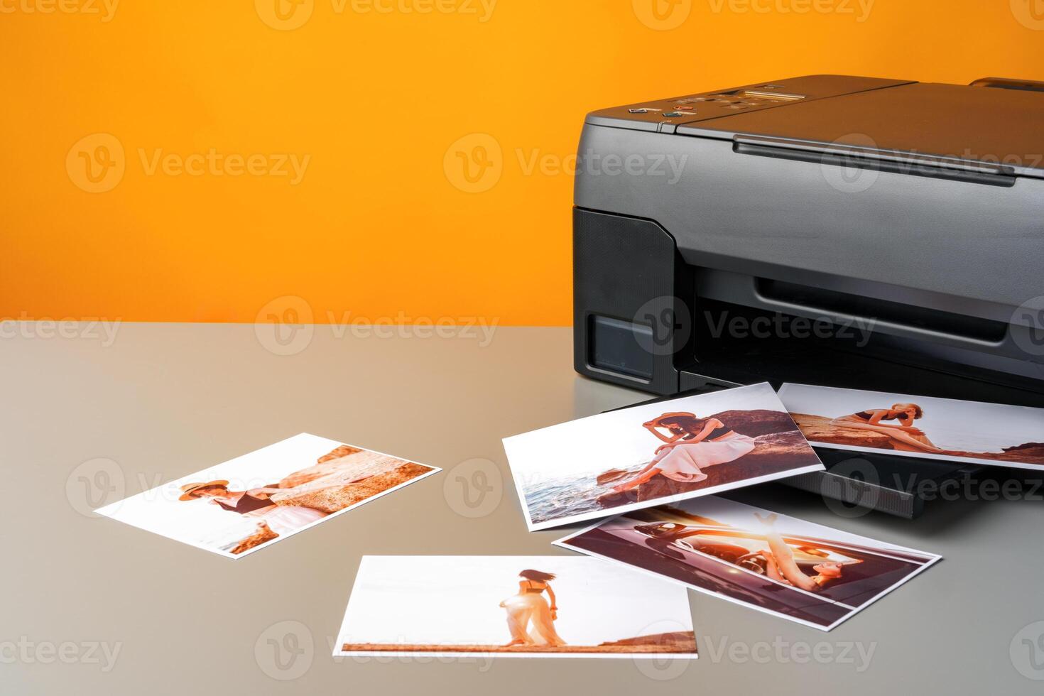 Printer printing colorful photos of people close up, yellow background