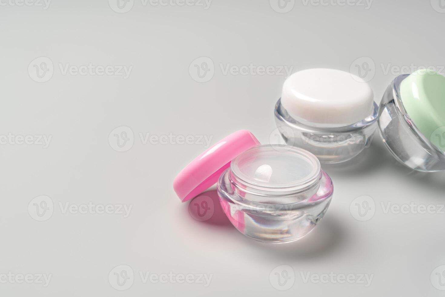 Colorful cosmetic containers arranged neatly on a light gray background photo
