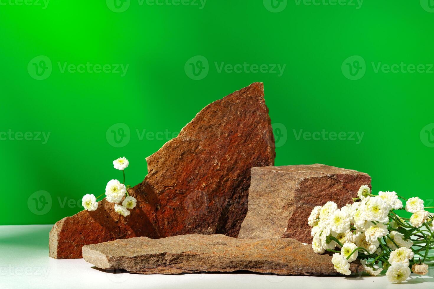 Mock up stone podium against green background photo