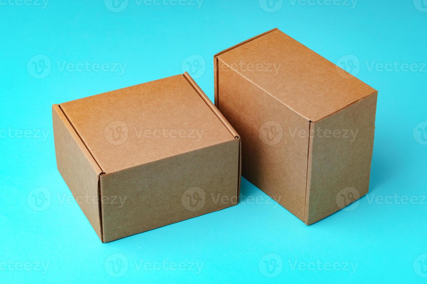 A collection of cardboard boxes arranged on a bright blue surface photo