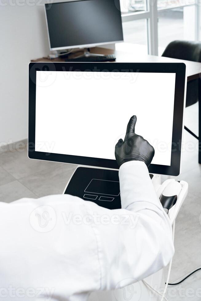 A person in gloves interacting with a touchscreen display in a modern office environment photo