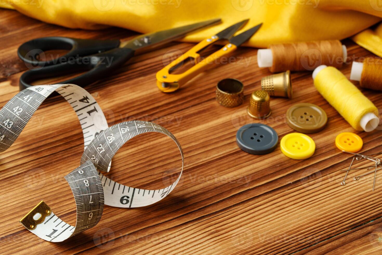 Crafting tools and materials arranged on a wooden table ready for sewing and creative projects photo