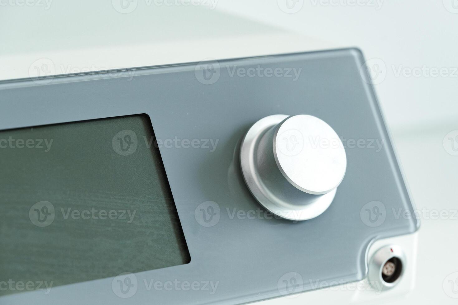 modern electronic control panel featuring a large rotary knob and digital display photo
