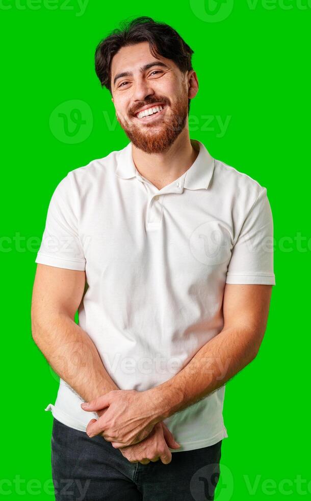 A man with a beard smiles confidently against a bright green background photo