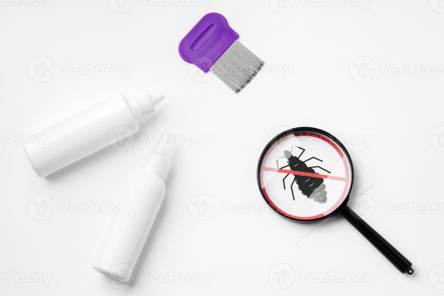 Tools for inspecting and treating lice infestations at home with a magnifying glass and a comb photo
