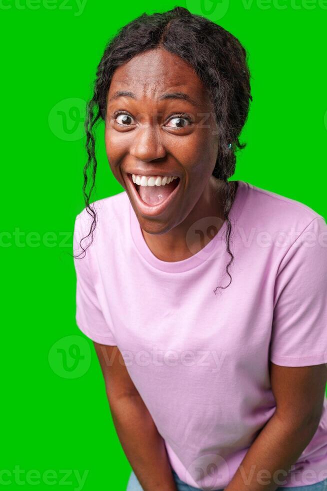 Woman expressing surprise and excitement on a bright green background photo