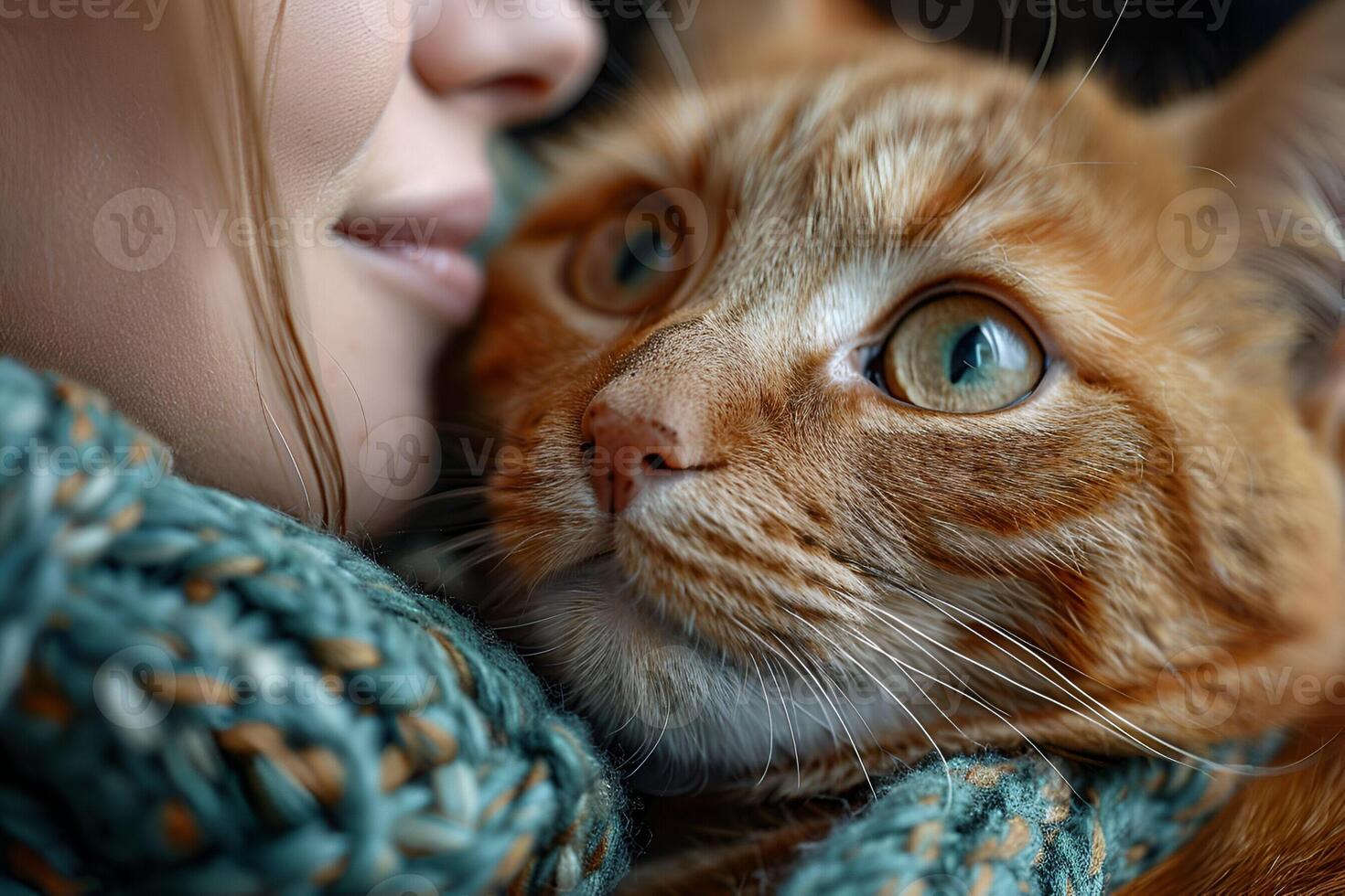 A Woman embracing a ginger cat with green eyes, showing a close bond filled with warmth and trust photo