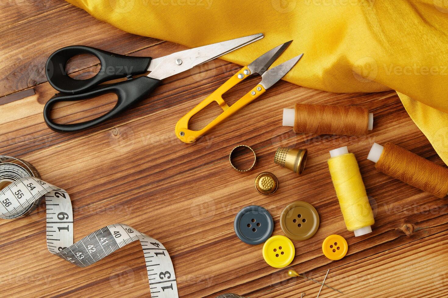 Crafting tools and materials arranged on a wooden table ready for sewing and creative projects photo