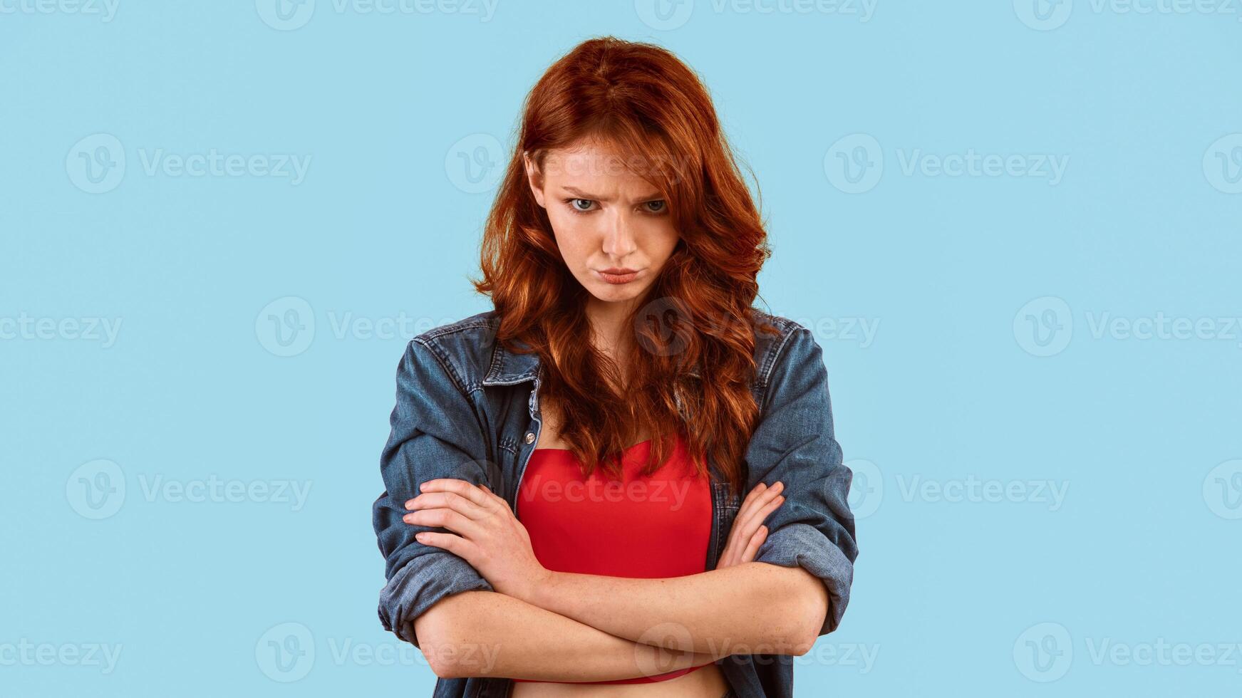Sulky Teen Girl Crossing Hands Looking At Camera Posing Over Yellow Studio Background. Panorama photo