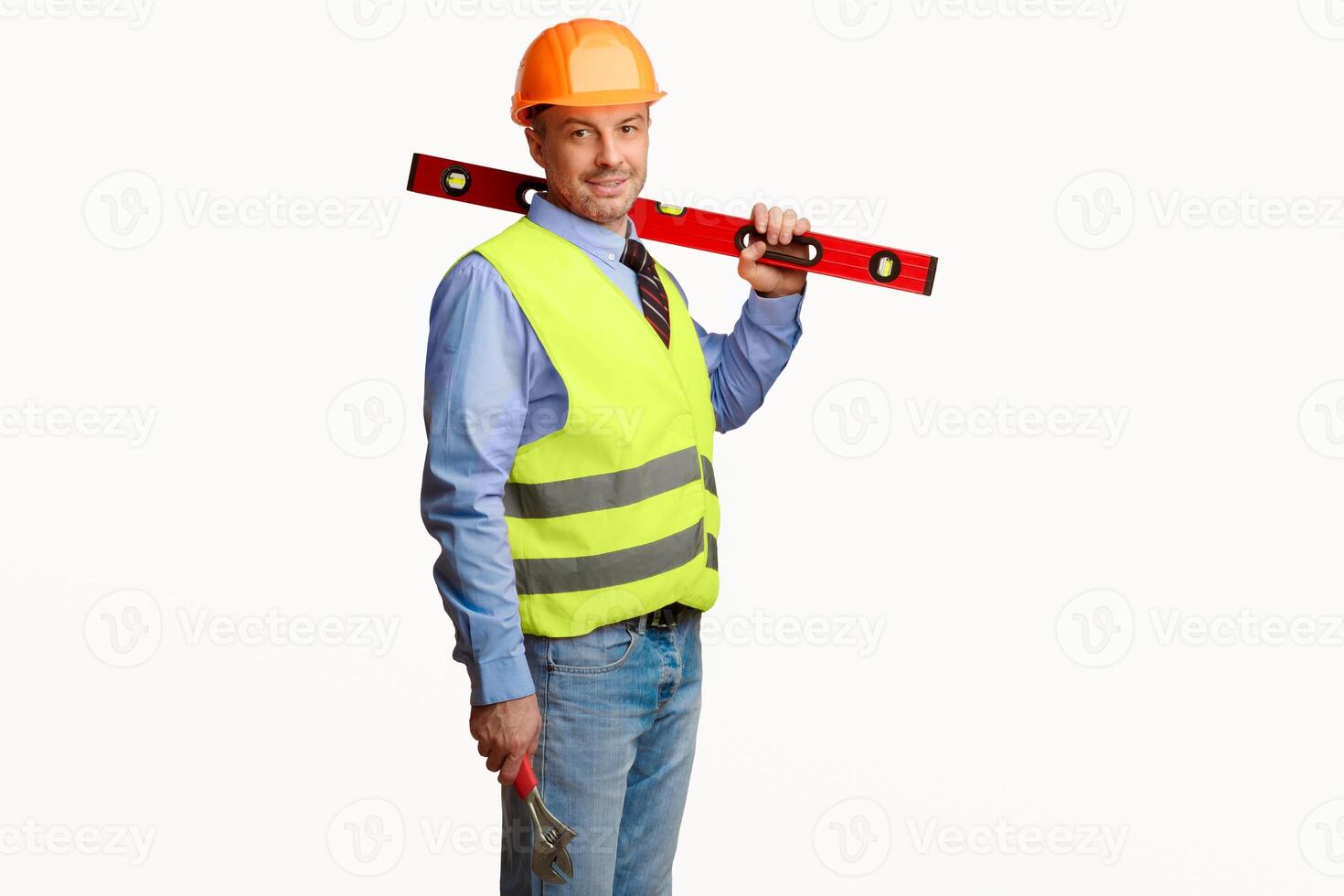 Worker Man Posing With Builder's Level Smiling To Camera Standing In Studio Over White Background. Building Equipment Concept. Copy Space photo