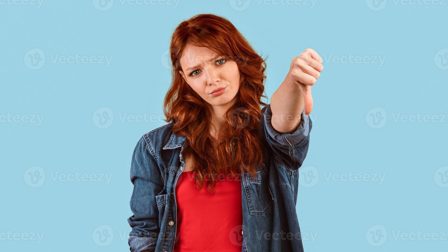 Dislike. Discontented Millennial Girl Gesturing Thumbs Down Disapproving Something Standing Over Yellow Studio Background. Panorama photo